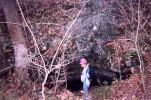  The entrance to a cave in Tennessee is barely visable on the hillside. 